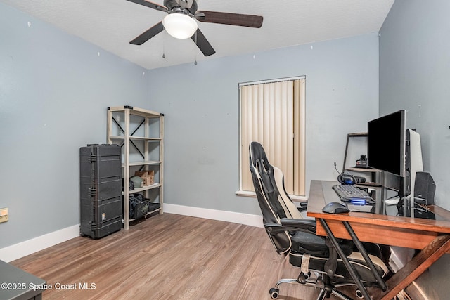 office space featuring a ceiling fan, wood finished floors, and baseboards