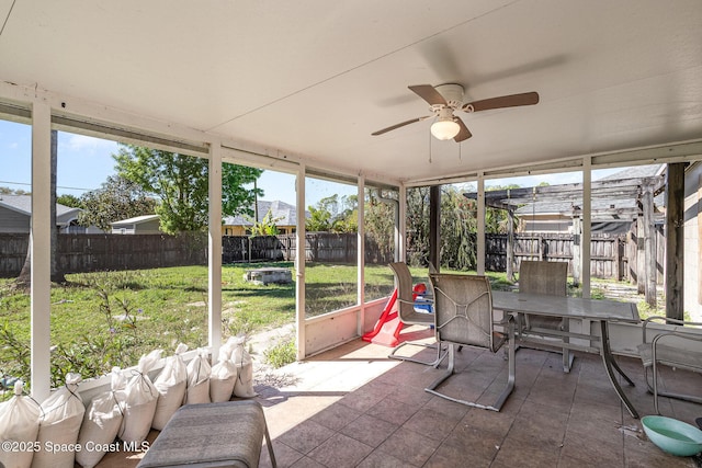 sunroom featuring ceiling fan