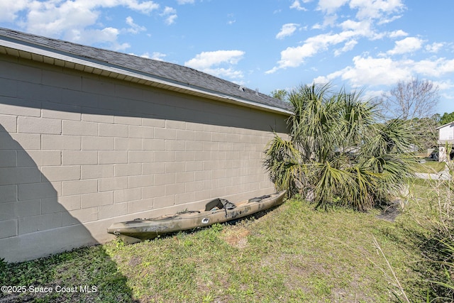 view of side of property featuring roof with shingles