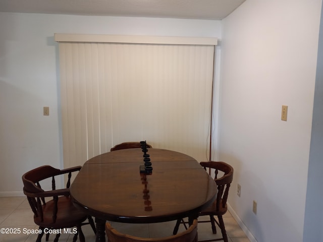 dining area with light tile patterned floors and baseboards