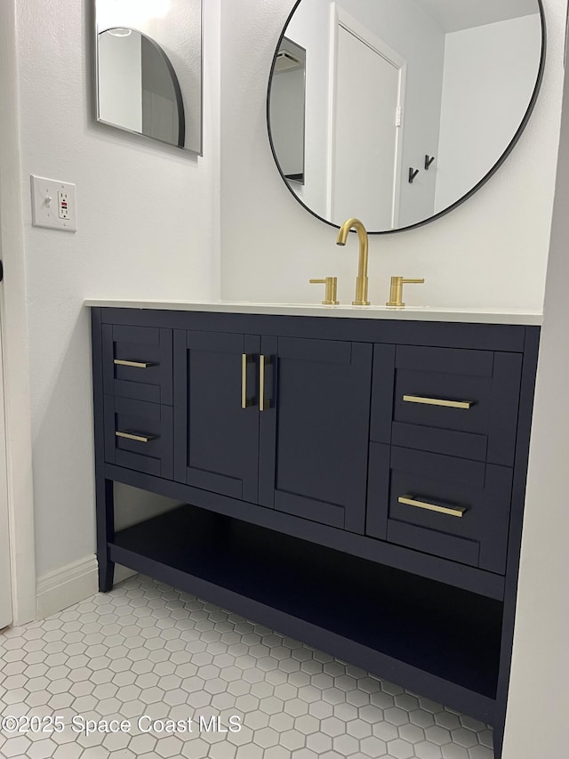 bathroom featuring tile patterned floors, vanity, and baseboards