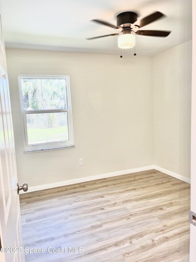 unfurnished room featuring ceiling fan, baseboards, and wood finished floors