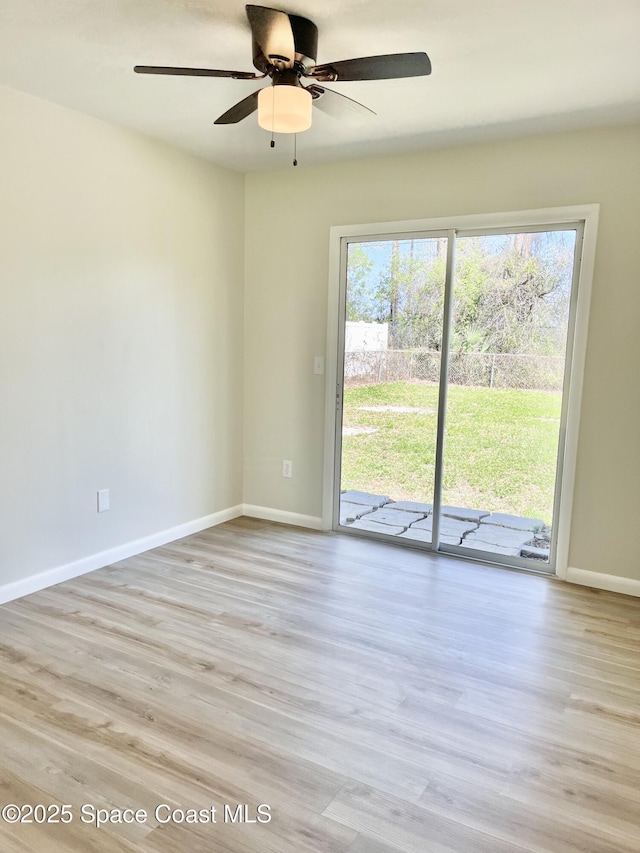 unfurnished room with wood finished floors, baseboards, a wealth of natural light, and ceiling fan