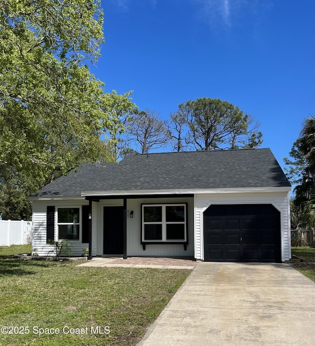 ranch-style house with fence, roof with shingles, a front yard, driveway, and an attached garage