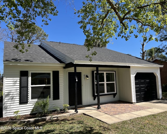 ranch-style home with an attached garage and roof with shingles