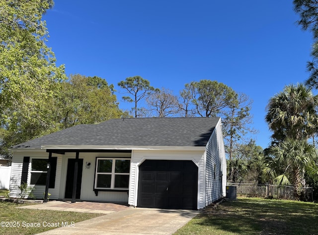 view of front facade featuring an attached garage, fence, cooling unit, and a shingled roof