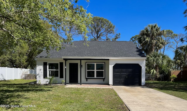 view of front of house with a front lawn, fence, concrete driveway, roof with shingles, and an attached garage