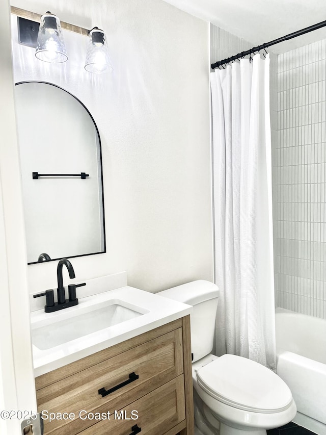 bathroom featuring shower / bath combo with shower curtain, toilet, and vanity