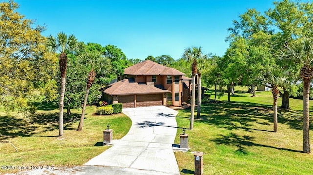 view of front of home with a garage, driveway, and a front yard