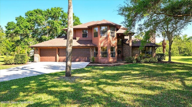 prairie-style house with a front lawn, an attached garage, and driveway