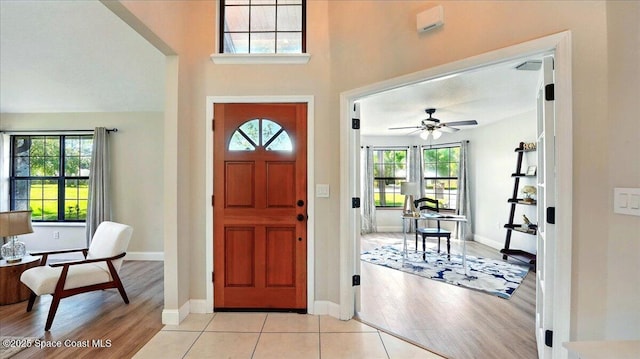 entryway featuring baseboards, light wood-style floors, and a ceiling fan