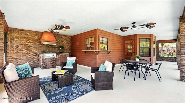 view of patio / terrace with outdoor lounge area, outdoor dining space, a ceiling fan, and an outdoor kitchen