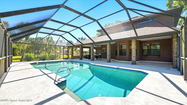 outdoor pool featuring a patio area, a lanai, and a ceiling fan