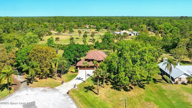 birds eye view of property with a view of trees