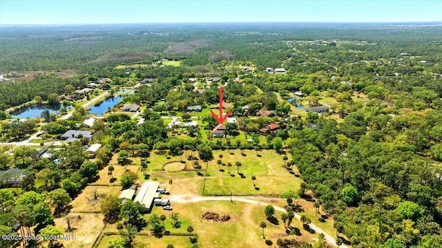 aerial view with a forest view and a water view