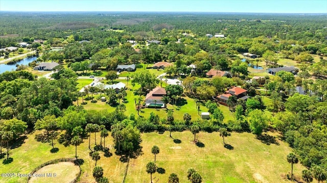 aerial view featuring a forest view and a water view