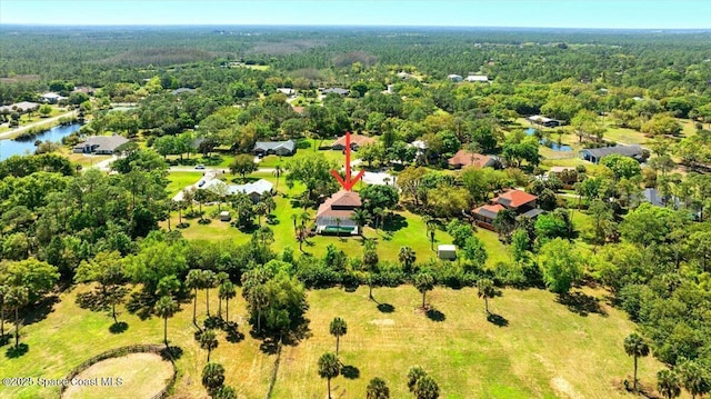 aerial view with a wooded view and a water view