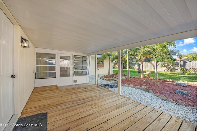 wooden terrace featuring fence