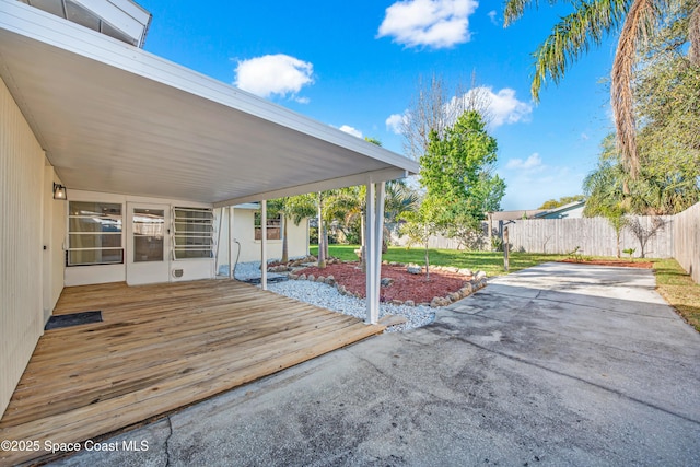 view of patio featuring a deck and fence