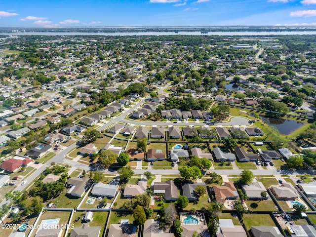 birds eye view of property with a residential view and a water view