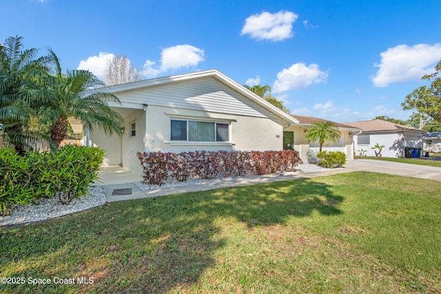 single story home with stucco siding, driveway, and a front lawn