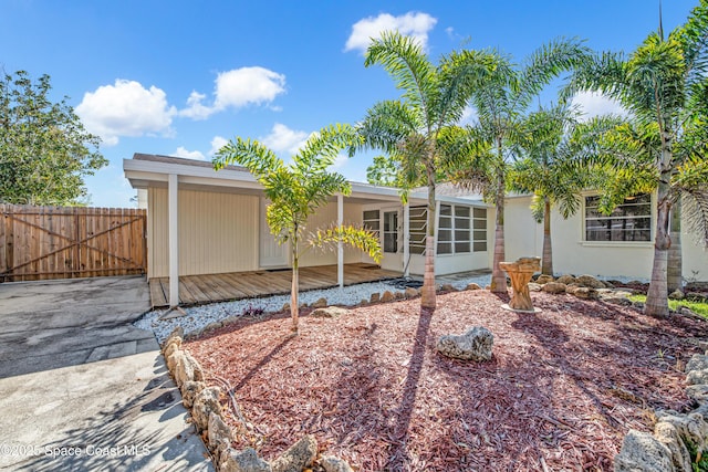 back of property with fence and stucco siding