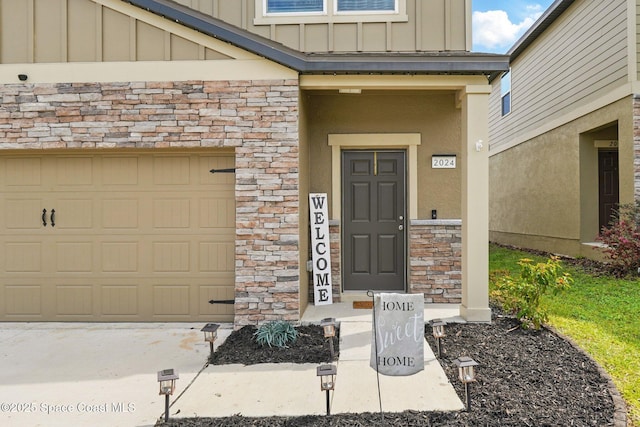 doorway to property with board and batten siding and stone siding