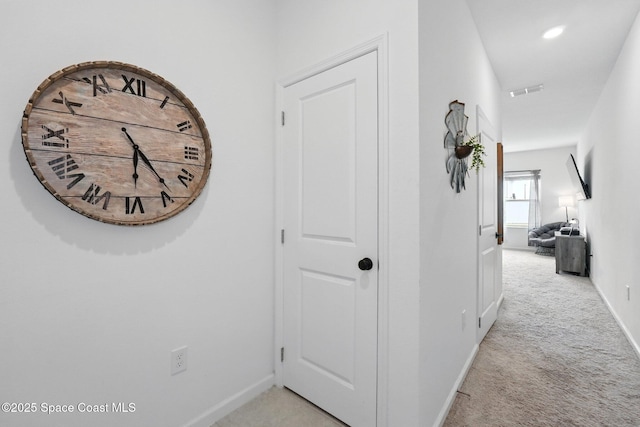corridor with light carpet, visible vents, recessed lighting, and baseboards