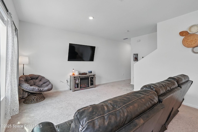 living room featuring carpet flooring and baseboards