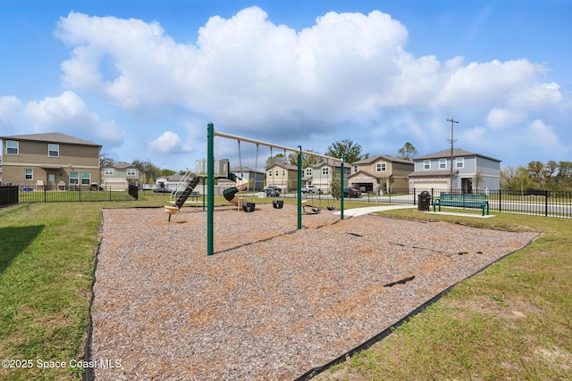 communal playground with a residential view, a yard, and fence