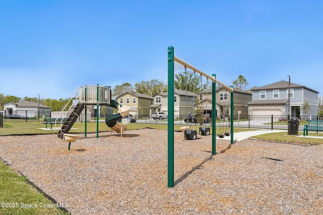 community playground with a residential view and fence