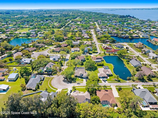 drone / aerial view with a residential view and a water view