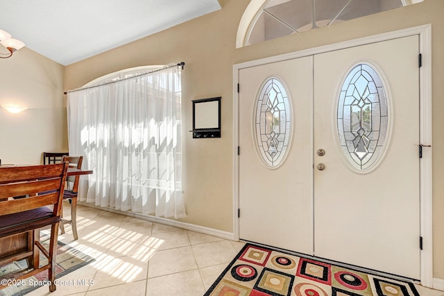 entryway featuring light tile patterned floors and baseboards