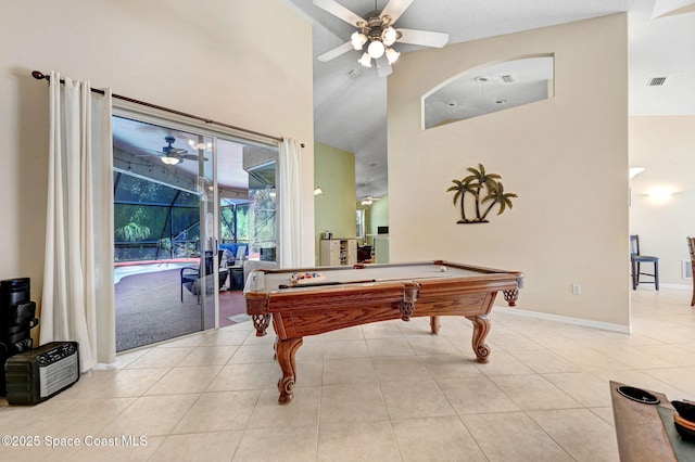 game room featuring tile patterned floors, visible vents, a ceiling fan, baseboards, and a towering ceiling