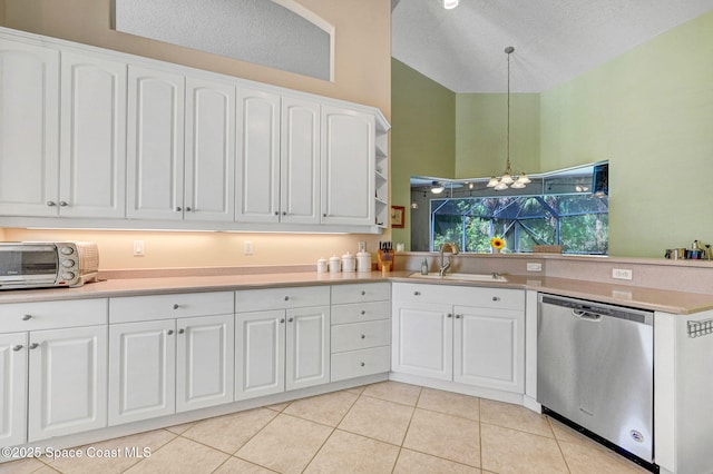 kitchen with light tile patterned floors, a toaster, a sink, dishwasher, and decorative light fixtures