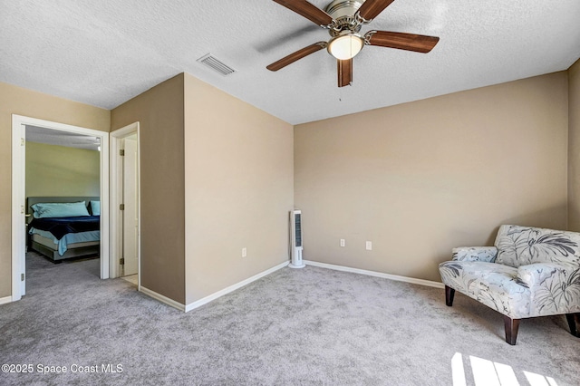 unfurnished room featuring visible vents, carpet floors, a textured ceiling, and baseboards