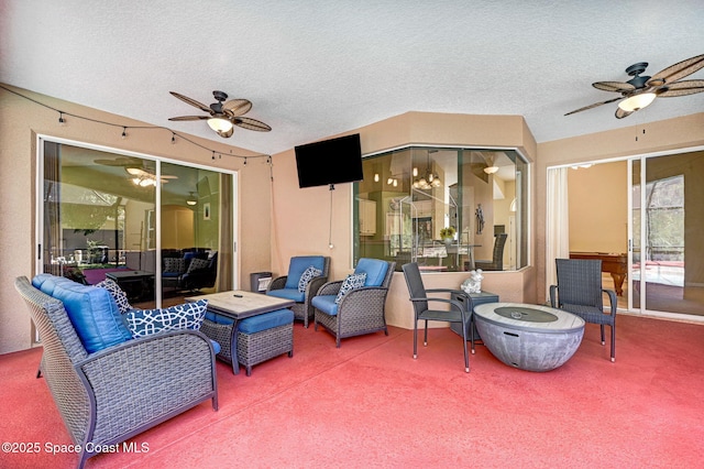 view of patio / terrace featuring an outdoor living space with a fire pit and a ceiling fan