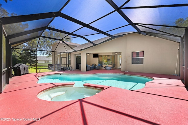 view of pool with a lanai, a patio area, and a pool with connected hot tub