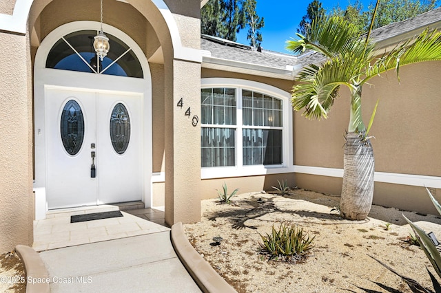 doorway to property with stucco siding