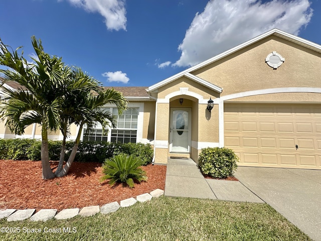 single story home featuring an attached garage, driveway, and stucco siding