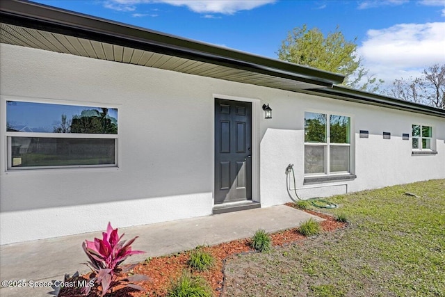 property entrance with stucco siding