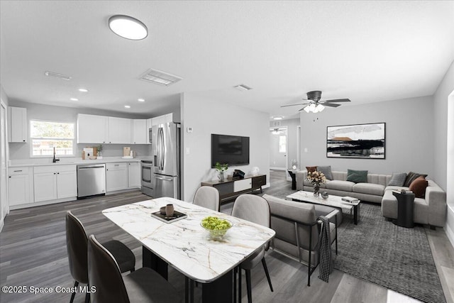 dining area featuring dark wood finished floors, recessed lighting, visible vents, and a ceiling fan