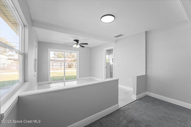 hallway featuring baseboards, visible vents, and marble finish floor