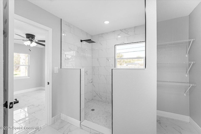 full bath featuring a spacious closet, baseboards, walk in shower, ceiling fan, and marble finish floor