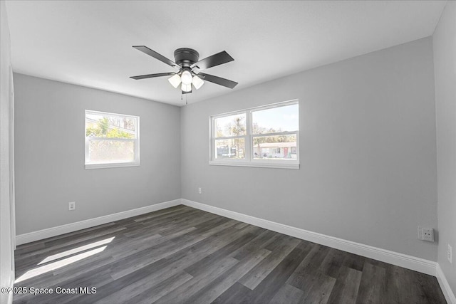 unfurnished room featuring dark wood-style floors, baseboards, and ceiling fan