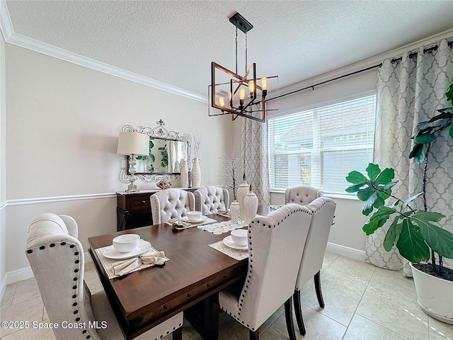 dining area featuring a textured ceiling, a chandelier, light tile patterned flooring, and ornamental molding