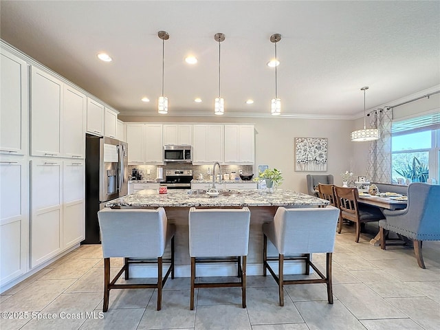 kitchen with backsplash, crown molding, white cabinets, stainless steel appliances, and a sink