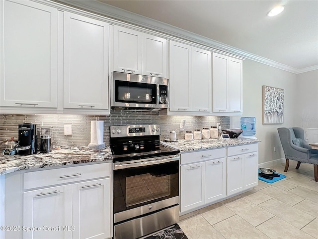 kitchen featuring tasteful backsplash, ornamental molding, light stone counters, appliances with stainless steel finishes, and white cabinets