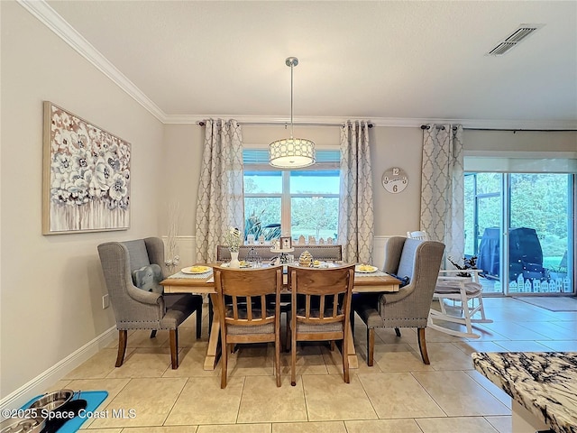 dining area with baseboards, a healthy amount of sunlight, visible vents, and ornamental molding