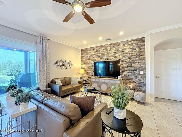 living room featuring light tile patterned floors, visible vents, ornamental molding, and a ceiling fan